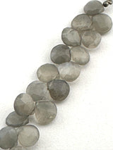 Gray moonstone heart beads next to a ruler, highlighting their 7.5-8mm size and faceted heart shape.