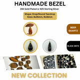 The longer 8x26mm Beer Quartz and Black Onyx drop connector held between fingers to show its elegant, slender shape and scale.