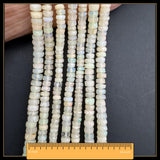 May include: Strands of yellow-toned gemstone beads. The beads are a mix of round and disc shapes, with a translucent quality. A ruler shows the strands are approximately 40.6 cm long.