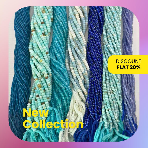 A beautiful collection of natural blue gemstone beads, including labradorite, lapis lazuli, and aquamarine, spread out on a white surface showing various sizes and shapes.