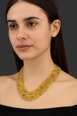 An artistic layout of faceted yellow gemstone beads in the flat Coin shape, highlighting their unique profile.