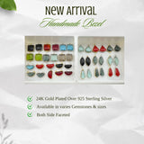 Collection of geometric gemstone pendants including a square, quarter circle, and tie shape in various colors.