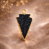 Black Druzy Arrowhead Pendant Necklace with 24K Gold 
Electroplated Bezel Setting — Handmade Gothic Jewelry 
Statement Piece on Sandy Background